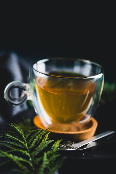 Cup of brewed tea with loose tea leaves