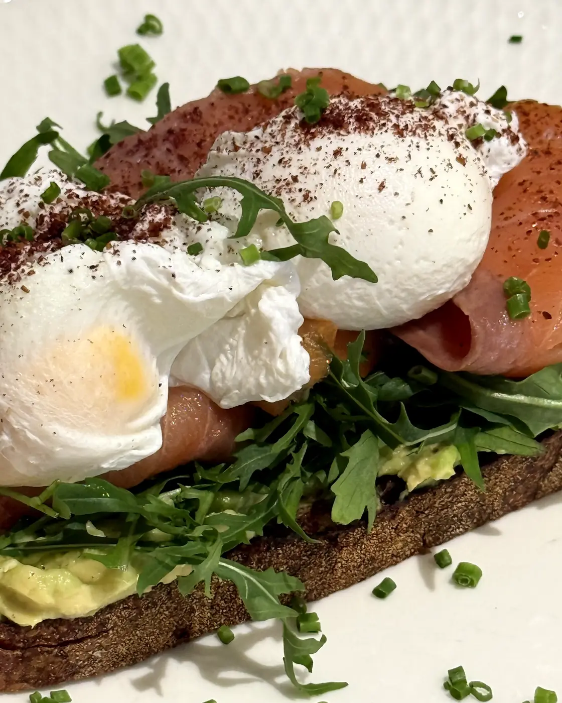 Smoked salmon toast with poached eggs, close up