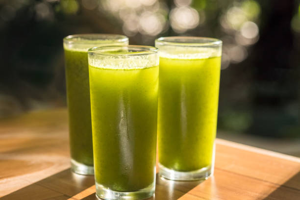 Fresh green smoothies in tall glasses